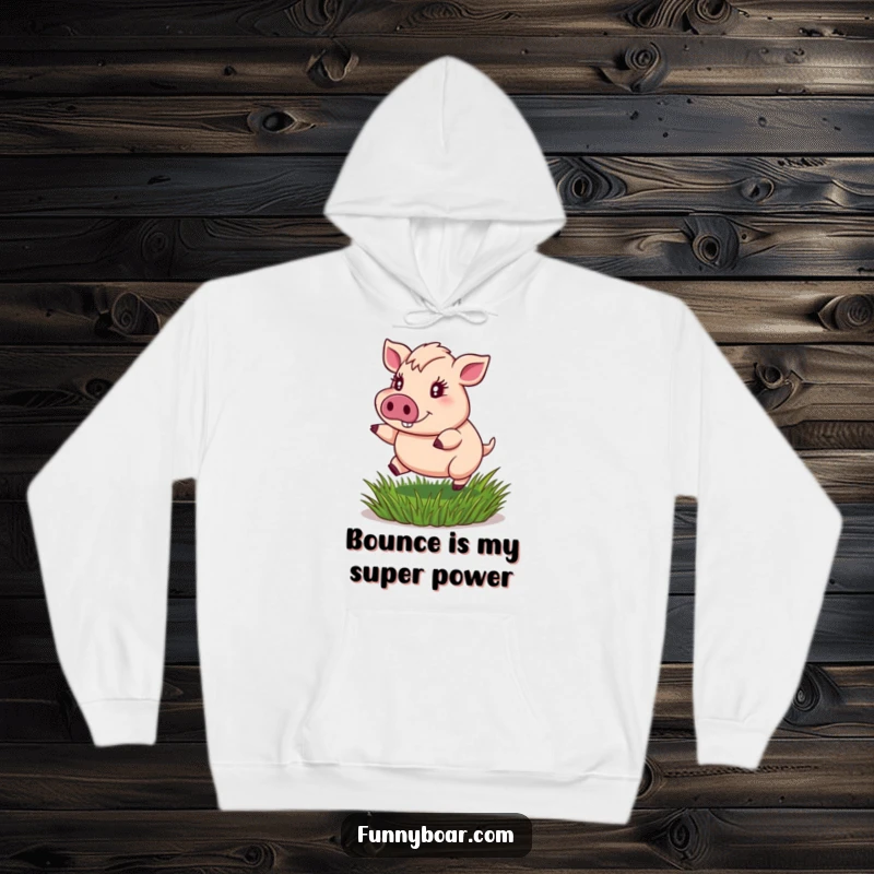 Funny hoodie: A portly boar with sparkling eyes gleefully bounces on a springy patch of grass, exuding joy and energy.